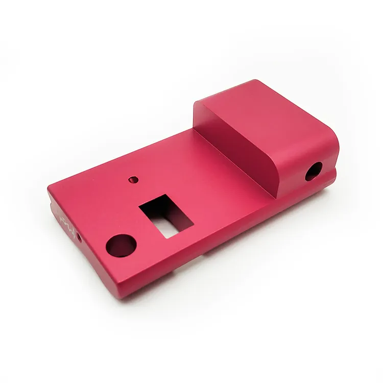 Red anodised aluminium plate with cut-outs and a raised block
