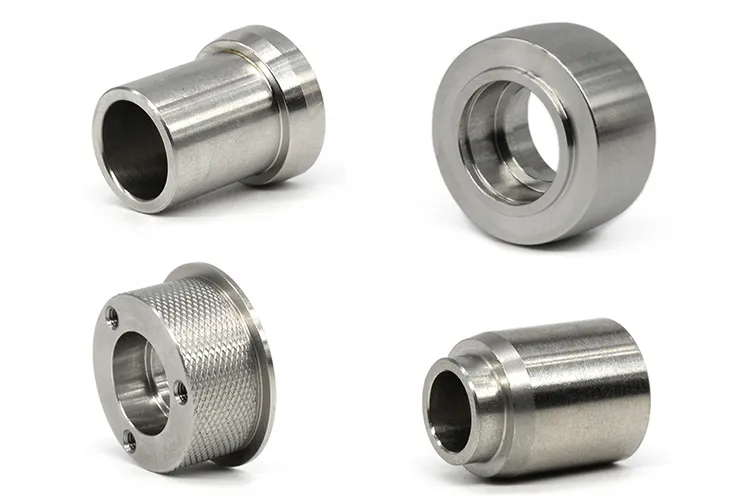 Four turned stainless steel collars and sleeves