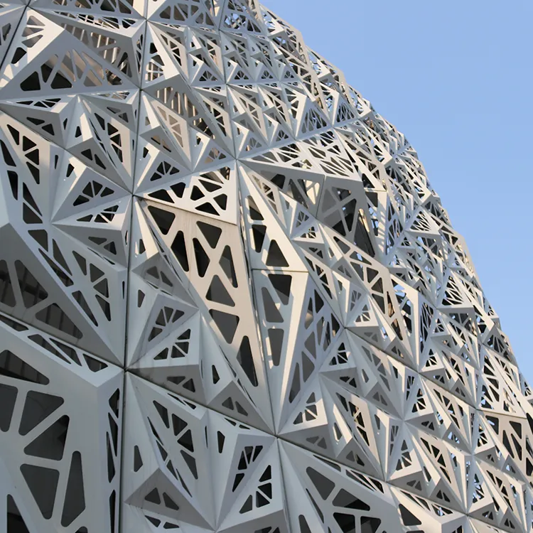 Building facade clad in white perforated aluminium panels
