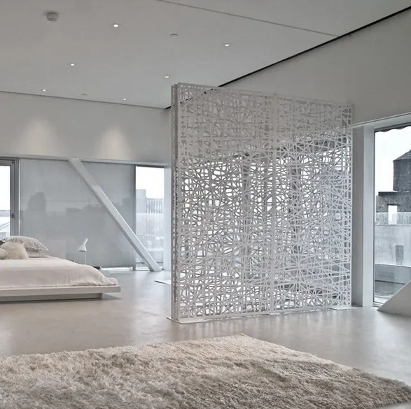 White perforated aluminium screen used as a room divider in a bedroom